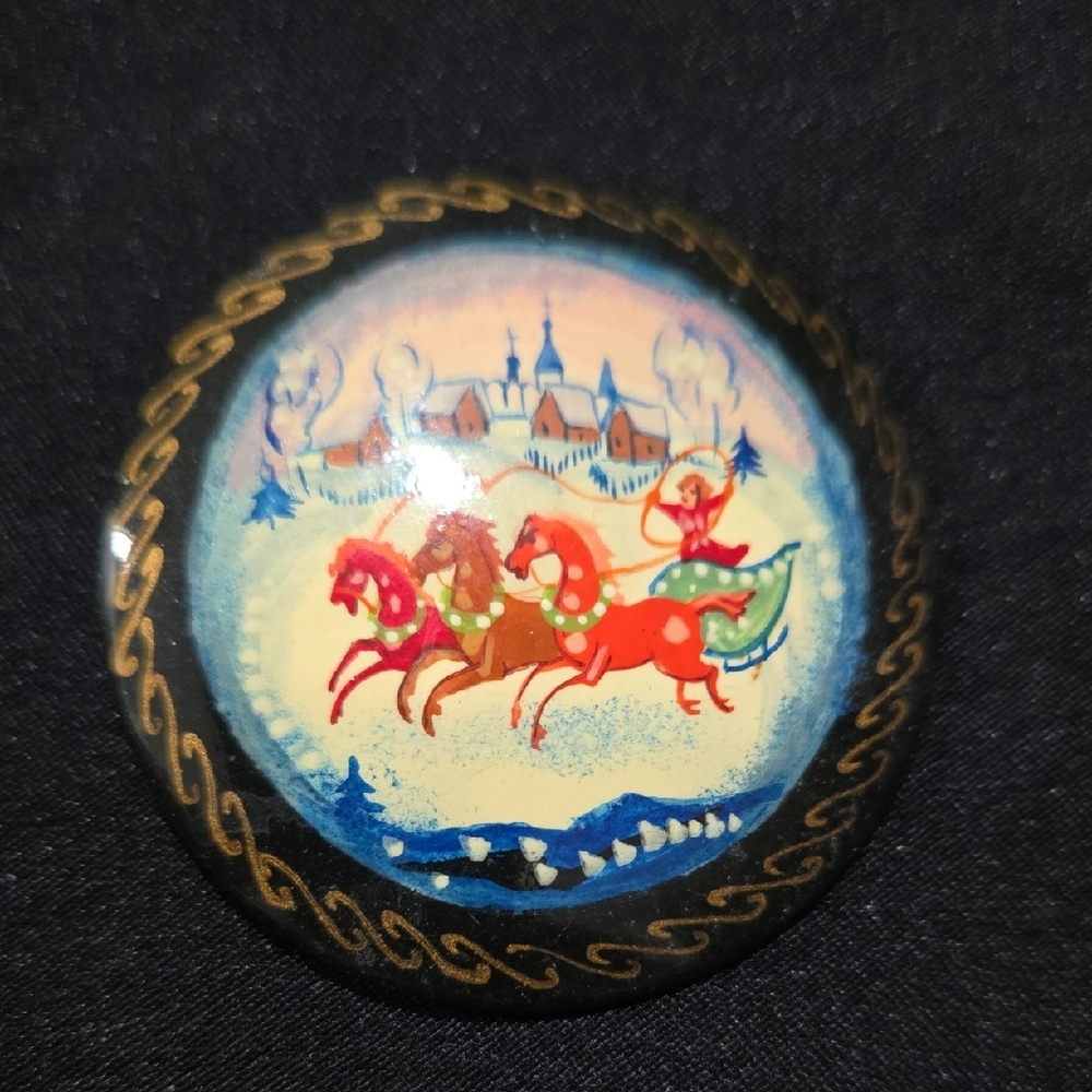 This is a vintage Russian hand-painted lacquer brooch hand-painted and signed